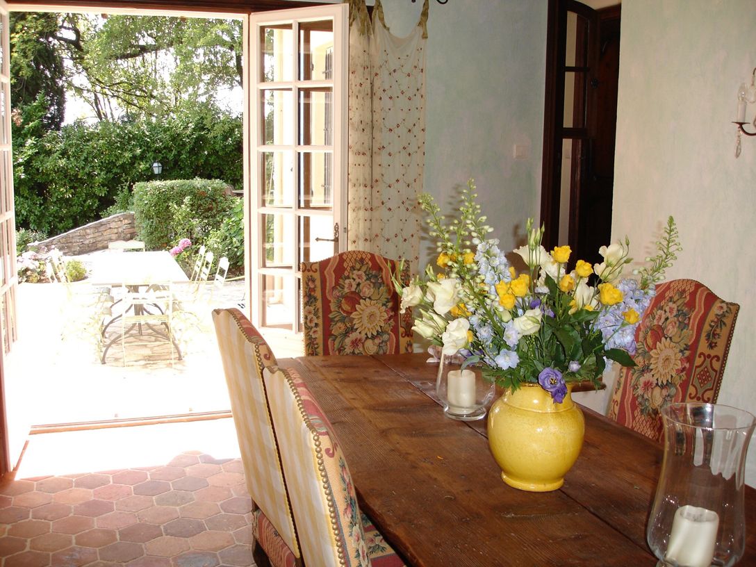 Dining room leads to another terrace with a long zinc table for 10 that has views  